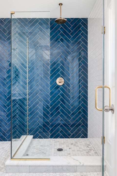 Tile shower with built-in bench and modern tile work for accessible bathing.