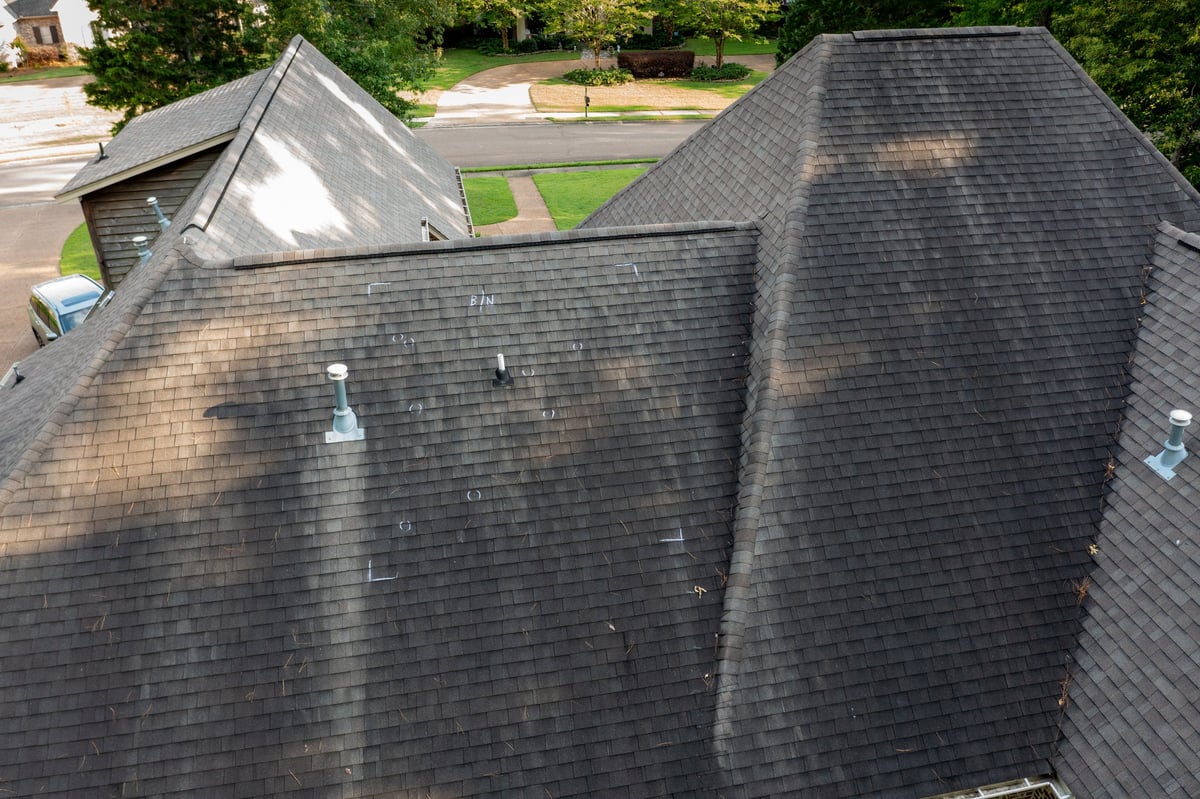 Roof with hail damage and chalk markings from inspection