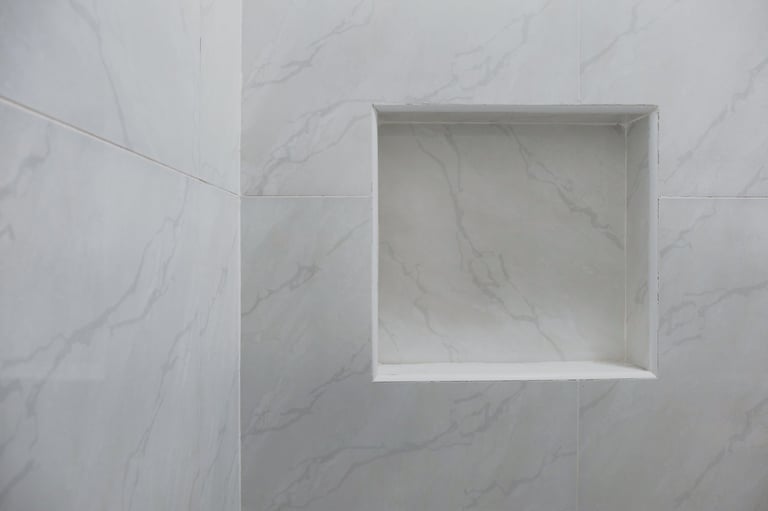 Built-in shower niche with tile surround, modern recessed shelf.