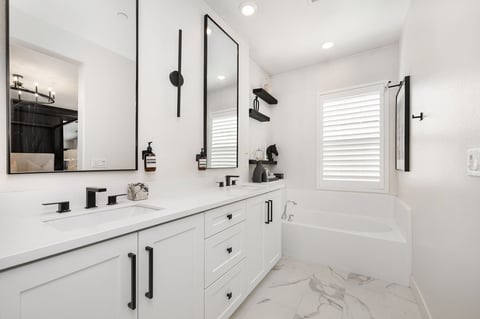 Bathroom with accessible threshold transition and clean modern finishes.