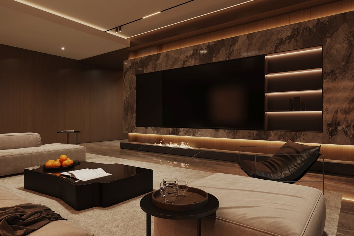 Modern finished basement with feature wall, large TV, and built-in fireplace