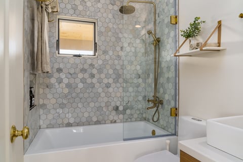 Modern bathroom with textured hexagonal floor tile for slip resistance.