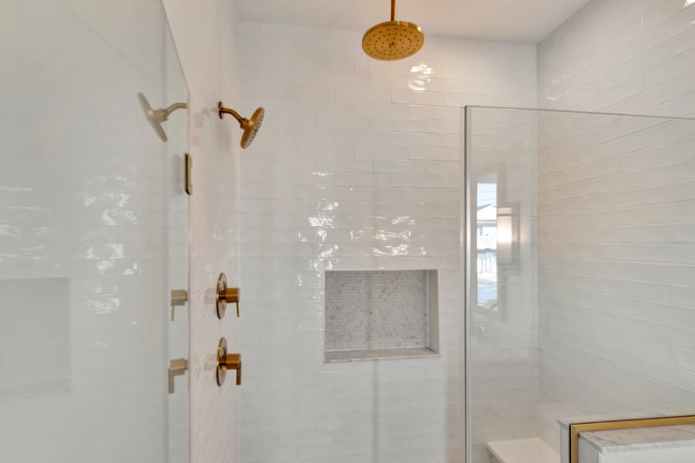 White tiled walk-in shower with glass door, modern product style.