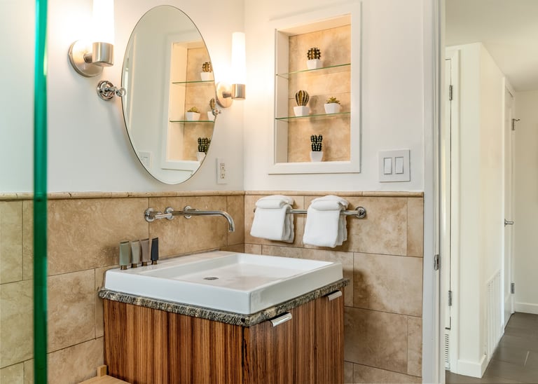 Modern floating wood vanity with round mirror.