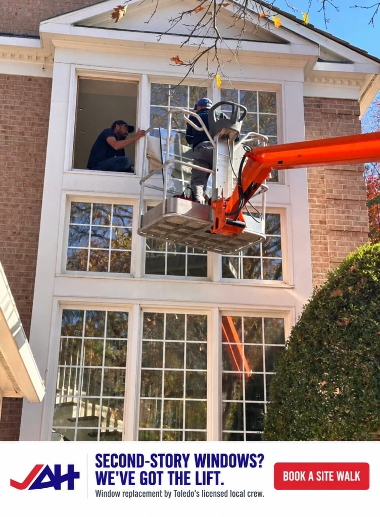 Just Ask Home Improvement crew member on a lift replacing second-story windows on a brick home