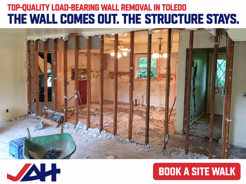 Interior of home under construction showing wooden frame of removed load-bearing wall in Toledo, with text advertising wall removal services.