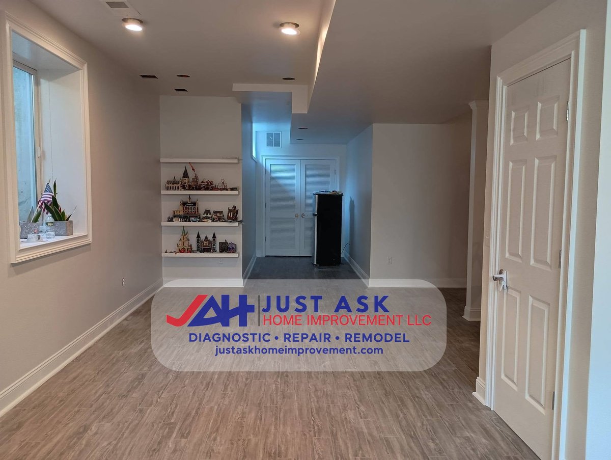 Completed residential hallway with repaired drywall ceiling, recessed lighting and finished painted walls