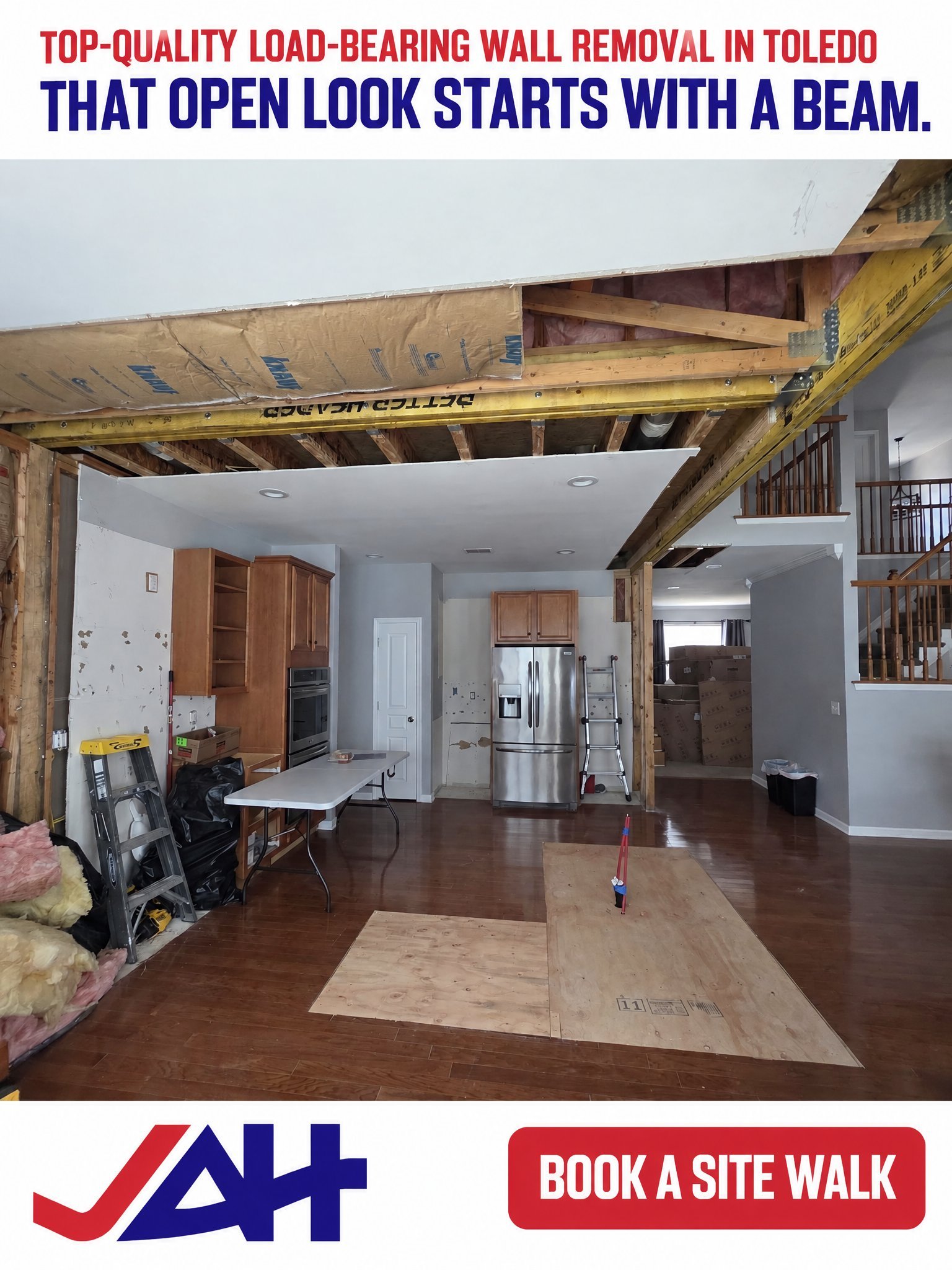 Interior home renovation showing load-bearing wall removal with yellow support beam installed, open kitchen and living space visible